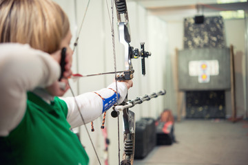 Girl shoots arrows at competitions from a block modern bow