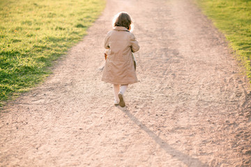 Fototapeta premium little girl with basket on the road