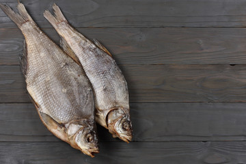 Dried fish on the table. Salty dry river fish on a dark wooden background.top view with copy space
