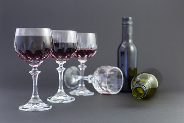 Getting drunk from red wine in elegant crystal glasses