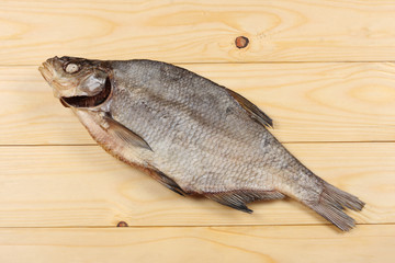 Dried fish on the table. Salty dry river fish on a light wooden background.top view with copy space