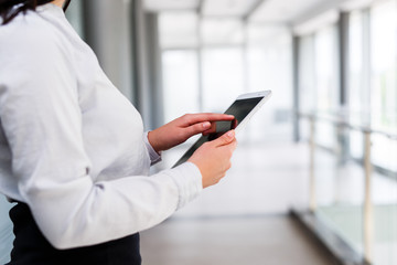 Modern business women holding tablet and toucing it