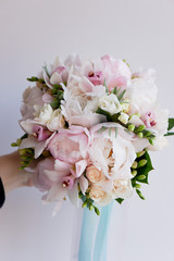 The bride's bouquet of soft pink peonies and white roses . Wedding floristry. Classic form