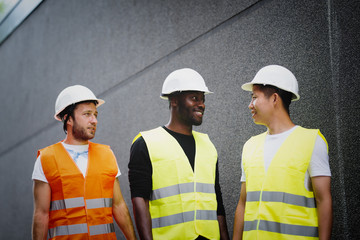 Three construction workers talking