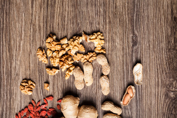 Mix of different type of nuts on wooden background in studio photo