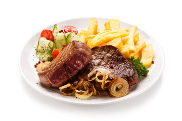 Grilled beefsteak with french fries on white background