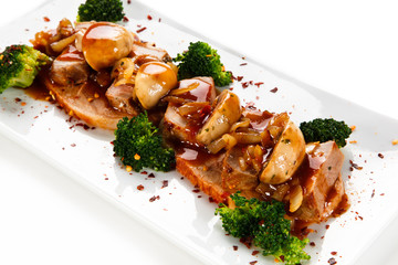 Grilled meat with broccoli and mushrooms on white background