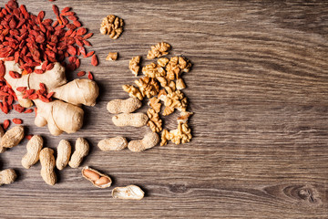 Mix of different type of nuts on wooden background in studio photo