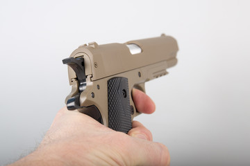 Hand holding modern air gun pistol