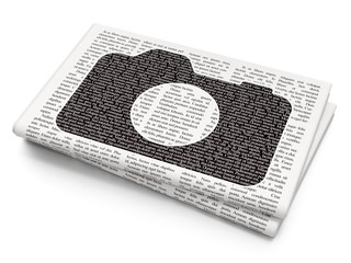 Tourism concept: Photo Camera on Newspaper background