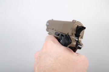 Hand holding modern air gun pistol
