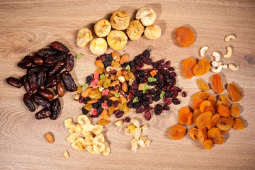 Mix of dried fruits on wooden background in studio photo. Healthy lifestyle