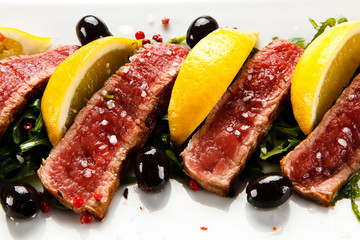 Carpaccio steaks on white background