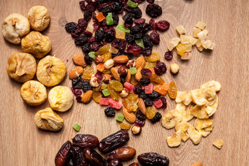 Mix of dried fruits on wooden background in studio photo. Healthy lifestyle