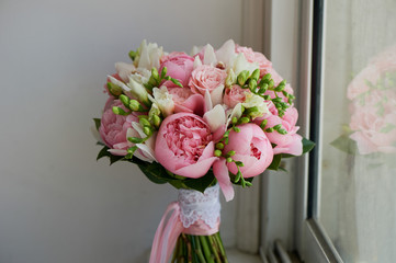 The bride's bouquet of soft pink peonies and white roses . Wedding floristry. Classic form