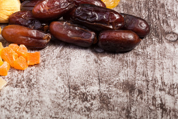 Mix of different dried fruits on wooden background in studio photo