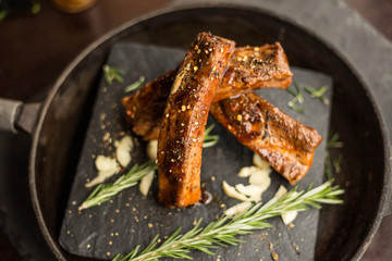 Roasted sliced barbecue pork ribs. Focus on sliced meat. Restaurant 