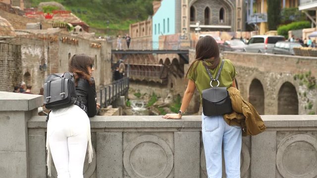 two women traveler are standing on the bridge