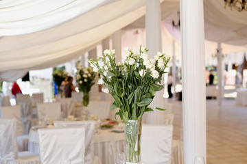 Wedding ceremony decoration in the restaurant. Decoration of wedding table with tender white textile