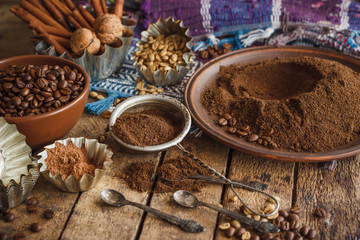 Roasted black and green coffee beans and ground coffee in the plate