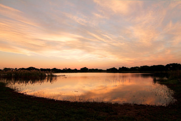 African sunset in Zululand over lake water reflections