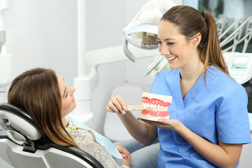 Dentist explaining how to brush teeth