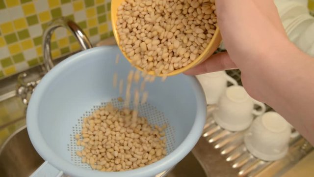 Wash the nuts in the colander in the kitchen.