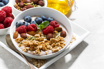 homemade muesli with yogurt and berries for breakfast, closeup