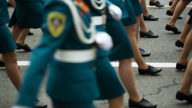Woman soldiers marching by the street