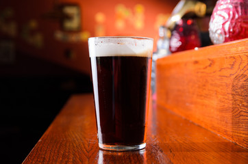 Glass of fresh beer on pub table