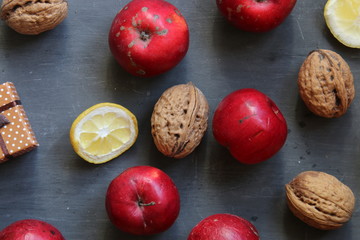 Apples and walnuts on the old table