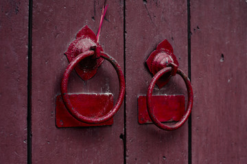 Antique red door handle in hoi an