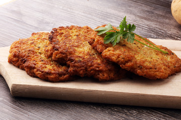 potato pancakes decorated with parsley on a cutting board on the table
