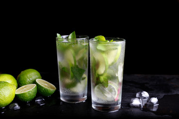 Mojito summer vacation refreshing tropical cocktail alcohol drink in highball glass, soda water beverage, lime juice, mint leaves, sugar, and rum