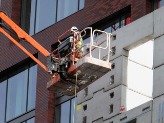 worker on an elevated construction platform on modern building development
