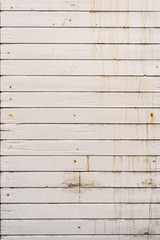 Dirty, old weathered white outside wooden plank wall.