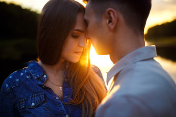 Fototapeta premium Cuddling couple. Couple in love. Love couple. Love hug. Love kiss. Couple kiss. Sunset 
