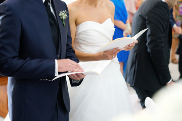 Obraz na płótnie Canvas Bride and groom during religious wedding ceremony