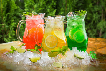 Summer cocktails in jugs in the ice with lime and mint, sangria