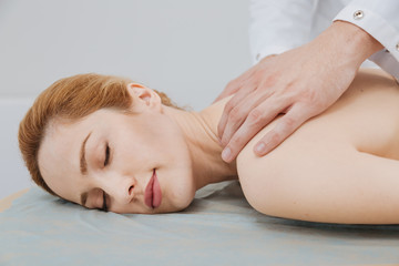 Young gorgeous woman enjoying the massage