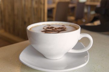 latte art coffee or cappuccino on wooden table background