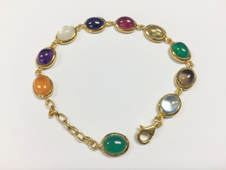 Colorful gemstones bracelet on white background