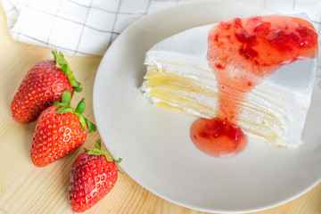 closeup delicious sweet dessert fresh strawberry syrup sauce and tasty crepe cake