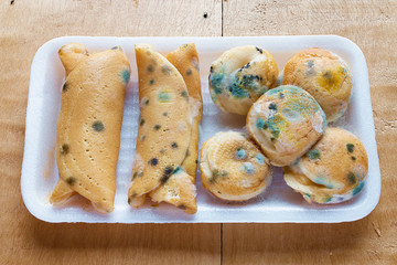 Bakery moldy, Moldy bread In foam box on the wooden table.
