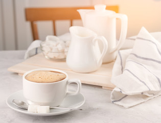Breakfast, Cup with coffee and milk on a white concrete background Sunlight