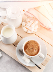 Breakfast, Cup with coffee and milk on a white concrete background Sunlight