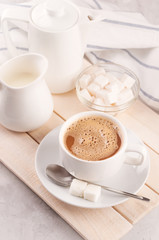 Breakfast, Cup with coffee and milk on a white concrete background Sunlight