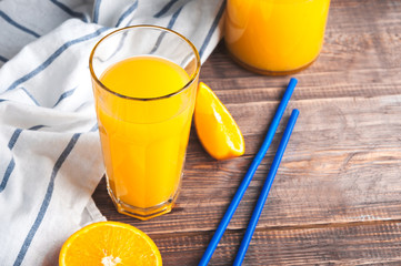 Fresh Orange Juice,Wooden Table,White Napkin, Straws.