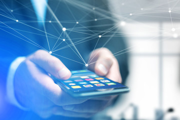 Hand of a businessman holding smartphone with operating system screen and network connection