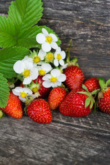 Fresh strawberries With flower and leaves on wooden table. space for text 